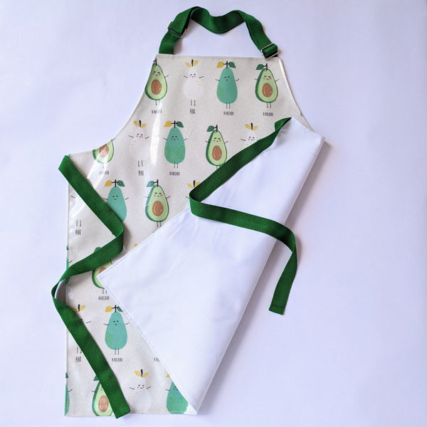 Large , Lined, Wipeable, Kids Pear and Avocado Oilcloth Apron, with front pocket and adjustable green neck band and green ties and trim.