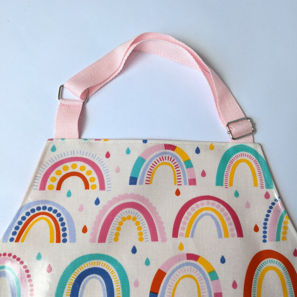 Close up of baby pink adjustable neck band on Kids Rainbow oilcloth apron