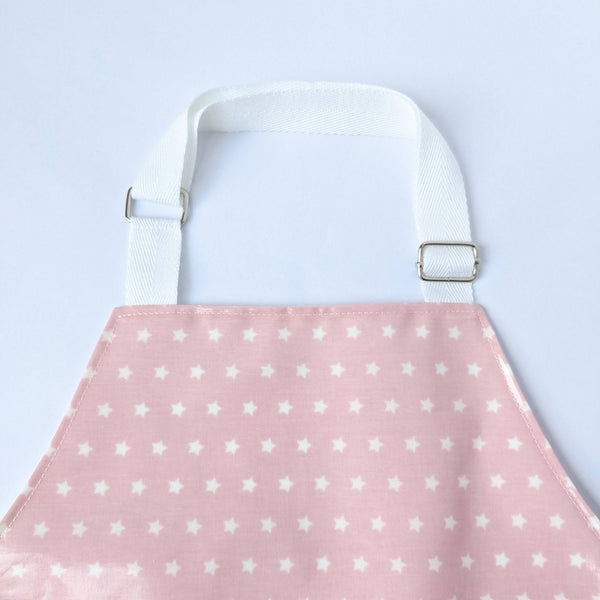 Close up of white adjustable neck band on kids Twinkle Pink oilcloth apron.