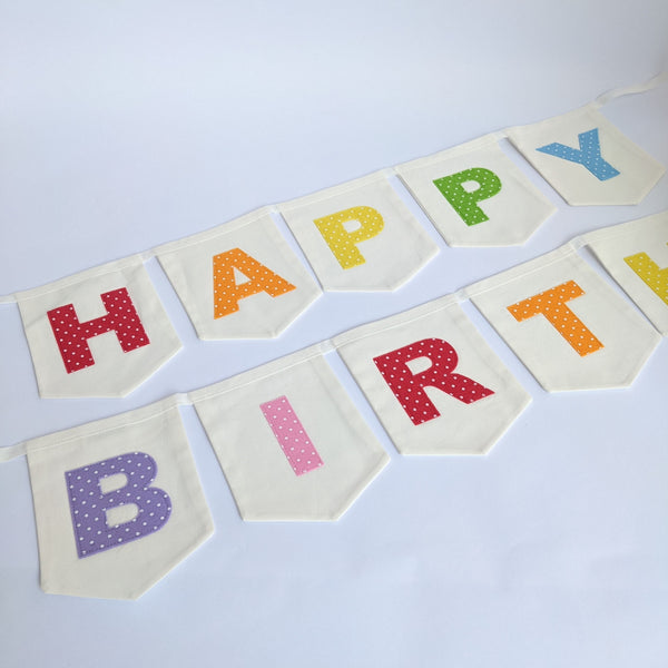 Close up of Pastel Rainbow Coloured  'Happy Birthday' Fabric Bunting